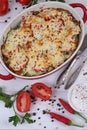 Zucchini casserole with cheese on a white wooden background
