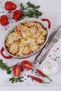 Zucchini casserole with cheese on a white wooden background