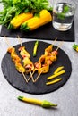 Zucchini and chicken kebab on wooden stick on black stone slate plate and grey background. Top view. Royalty Free Stock Photo