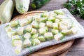 Zucchini cubes on a kitchen towel. Frozen zucchini