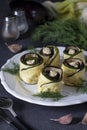 Zucchini and eggplant rolls with garlic and cream cheese on a plate on a dark gray background Royalty Free Stock Photo