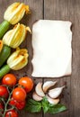 Zucchini with flowers, tomatoes, basil, garlic and pepper on da Royalty Free Stock Photo