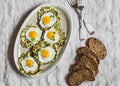 Zucchini fritters with fried quail eggs. Delicious breakfast or snack on a gray table, top view.