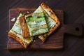 Zucchini galette cut in squares, crusty appetizer savory pastry