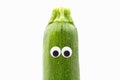 Zucchini with googly eyes on white background