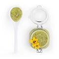 Zucchini green sauce in jar with flowers and spoon food top view