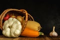 zucchini in a lying wicker basket. traditional autumn still life of vegetables on a black concrete background. artistic dark