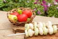 Zucchini and mushrooms on metal skewers on wooden chopping board