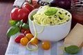 Zucchini noodles in a bowl with fresh vegetables