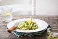 Zucchini noodles with pesto sauce on wooden table Royalty Free Stock Photo