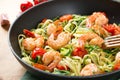 Zucchini noodles sauteed with cherry tomato and prawns in a pan Royalty Free Stock Photo