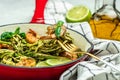 Zucchini pasta with pesto sauce and grilled shrimp in pan. Food recipe background. Close up Royalty Free Stock Photo