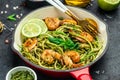 Zucchini pasta with pesto sauce and grilled shrimp in pan. Food recipe background. Close up Royalty Free Stock Photo