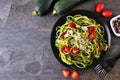 Healthy eating, low carb diet zucchini pasta. Top down view table scene on a dark slate background. Royalty Free Stock Photo