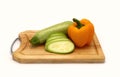 Zucchini and ripe yellow bell pepper on a cutting board on a light background. Royalty Free Stock Photo