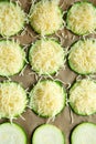 Zucchini slices with grated cheese ready to bake