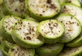 Zucchini slices with seasonings before cooking. Zucchini recipes Royalty Free Stock Photo