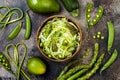 Zucchini spaghetti or noodles zoodles bowl with green veggies and garlic scape pesto. Top view, overhead. Royalty Free Stock Photo