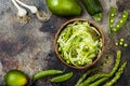 Zucchini spaghetti or noodles zoodles bowl with green veggies. Top view, overhead, copy space. Royalty Free Stock Photo