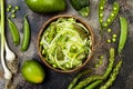 Zucchini spaghetti or noodles zoodles bowl with green veggies. Top view, overhead, copy space. Royalty Free Stock Photo