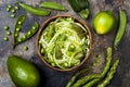 Zucchini spaghetti or noodles zoodles bowl with green veggies. Top view, overhead, copy space. Royalty Free Stock Photo