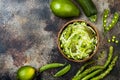 Zucchini spaghetti or noodles zoodles bowl with green veggies. Top view, overhead, copy space.