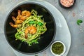 Zucchini spaghetti Pasta with basil pesto sauce and grilled shrimp, Vegetarian healthy food, place for text, top view Royalty Free Stock Photo