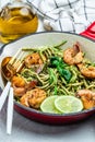 Zucchini spaghetti with pesto sauce and grilled shrimp skewers in pan. keto low carb diet. banner, menu, recipe place for text, Royalty Free Stock Photo