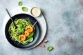 Zucchini spaghetti with pesto sauce and grilled shrimp skewers. Vegetarian vegetable low carb pasta. Zucchini noodles or zoodles. Royalty Free Stock Photo