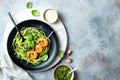 Zucchini spaghetti with pesto sauce and grilled shrimp skewers. Vegetarian vegetable low carb pasta. Zucchini noodles or zoodles. Royalty Free Stock Photo