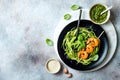 Zucchini spaghetti with pesto sauce and grilled shrimp skewers. Vegetarian vegetable low carb pasta. Zucchini noodles or zoodles. Royalty Free Stock Photo