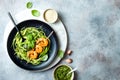 Zucchini spaghetti with pesto sauce and grilled shrimp skewers. Vegetarian vegetable low carb pasta. Zucchini noodles or zoodles. Royalty Free Stock Photo