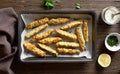 Zucchini sticks with panko breadcrumbs in baking dish