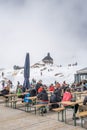 Zugspitze, Germany - Aug 5, 2020: tourist wear mask at sonnalpin in summer snow