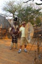 Zulu Chief posing with tourist in Shakaland Zulu Village, South Africa