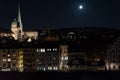 Zurich city by night with full moon shinging and light on buildings Royalty Free Stock Photo