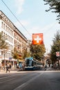 ZURICH, SWITZERLAND - AUG 23, 2018: A tram drives down the center of Bahnhofstrasse while people walk on the sidewalks in Zurich,