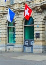 Credit Suisse building at Paradeplatz square in the city of Zurich decorated with flags