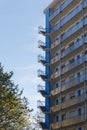 04.25.2019 zurich switzerland city: in viaduct area blue white skyscraper with many stairs next to deciduous tree and blue sky in