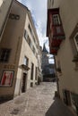 Narrow street in old Zurich. In the distance the clock tower of St. Peter\'s Church Royalty Free Stock Photo