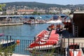 Red lifeboats lined up next to the dock on the clear blue Zurich lake on sunny day with buildings  in background. Rescue boats in Royalty Free Stock Photo