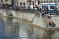 Young people enjoying sunny weather near Limmat river in Zurich, Switzerland