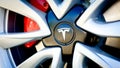 Zurich, Switzerland - May, 2020, Close-up of famous car manufacturer Tesla logo on grey wheel rim with red brakes