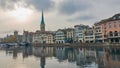 ZURICH, SWITZERLAND - November 28, 2018: Houses on the Limmat river embankment. Spire of the Fraumunster Church Royalty Free Stock Photo