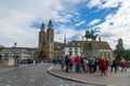 Group of tourists visiting the equestrian monument of Hans Waldmann and the GrossmÃÂ¼nster church