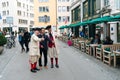 Zurich, ZH / Switzerland - April 8, 2019: Asian tourists taking photographs and selfies with traditional guildsmen in costume