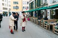 Zurich, ZH / Switzerland - April 8, 2019: Asian tourists taking photographs and selfies with traditional guildsmen in costume