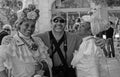 Cuba: Two photo models in colonial styl dresses are posing with male tourist in Havanna