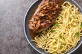 Zwiebelrostbraten Swabian Beef Roast with fried onions and spaetzle closeup on the plate. Horizontal top view Royalty Free Stock Photo