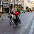 Zwolle, Overijssel, The Netherlands, Three young girls driving the bike in the shopping streets of old town Royalty Free Stock Photo